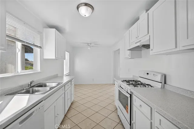 a kitchen with sink refrigerator and stove