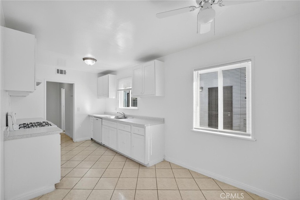 1613 West Piru Street Compton, CA 90222 - Photo 38 of 40 a kitchen with a cabinets and window