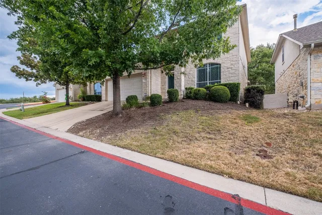 a view of a house with a tree in front of it