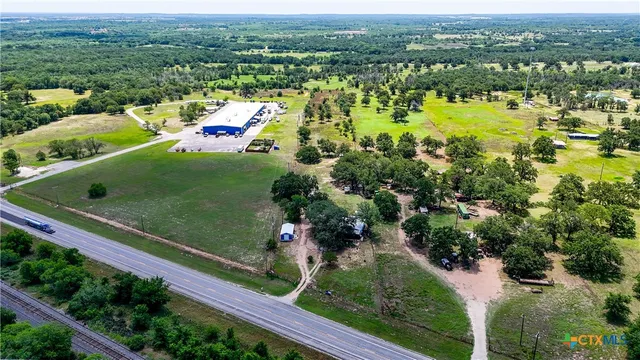 a living room with furniture a flat screen tv and a window