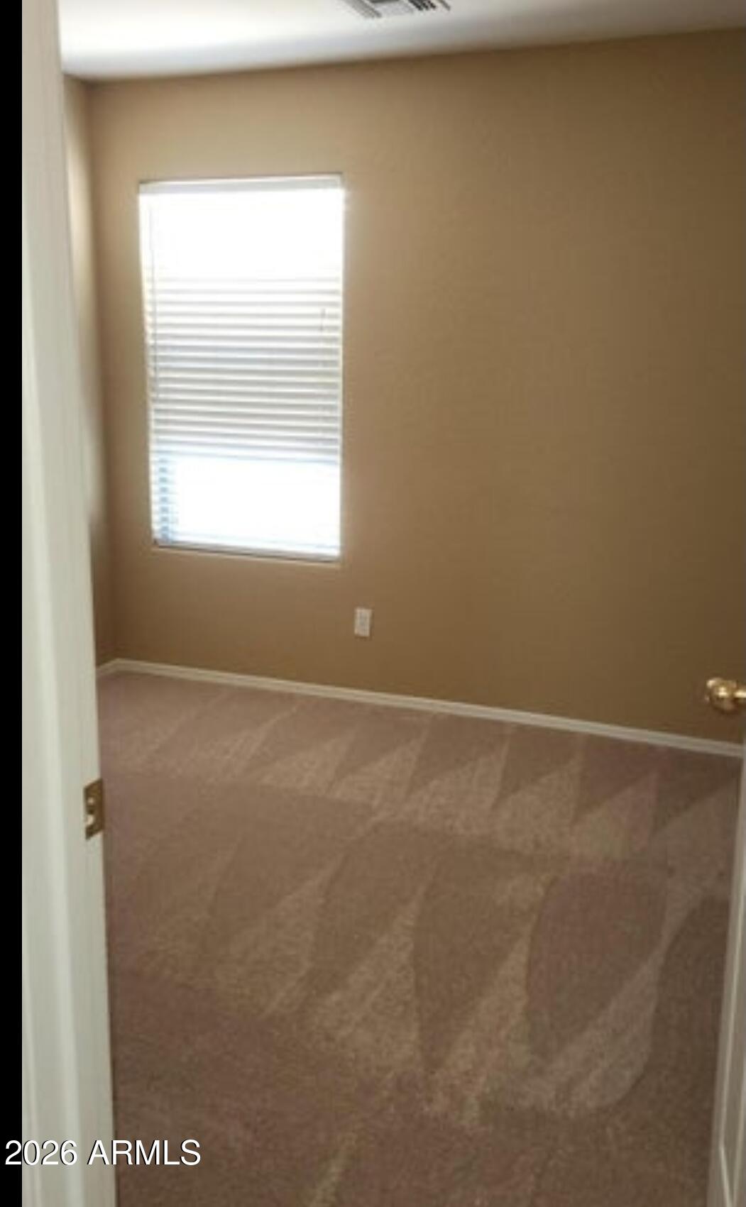 2134 West Pleasant Lane Phoenix, AZ 85041 - Photo 11 of 23 a view of an empty room with a window