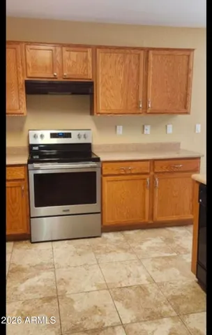 a kitchen with a stove top oven cabinets and a counter top space