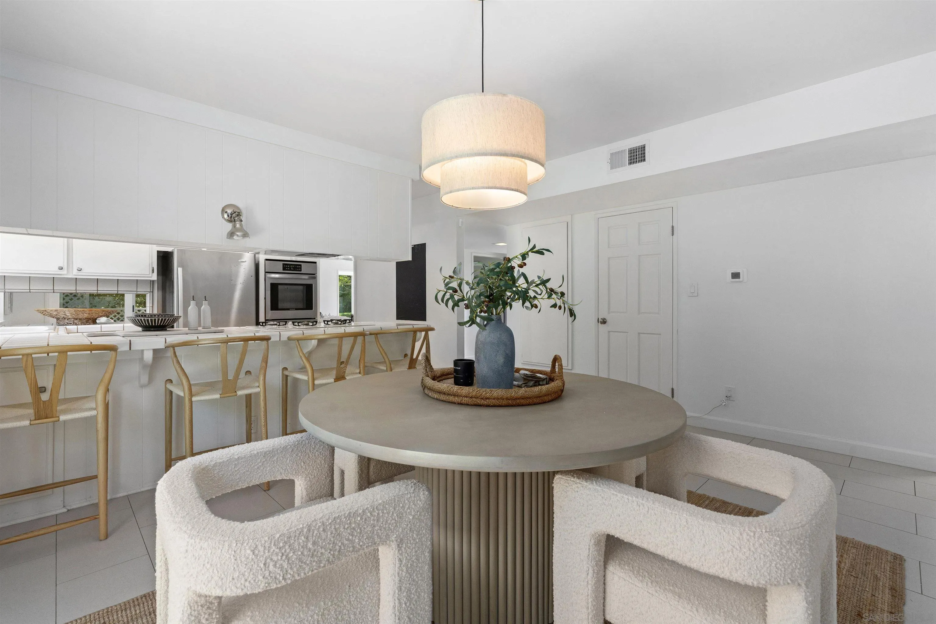 445 Avenida Primavera Del Mar, CA 92014 - Photo 21 of 44 a kitchen with a table and chairs in it