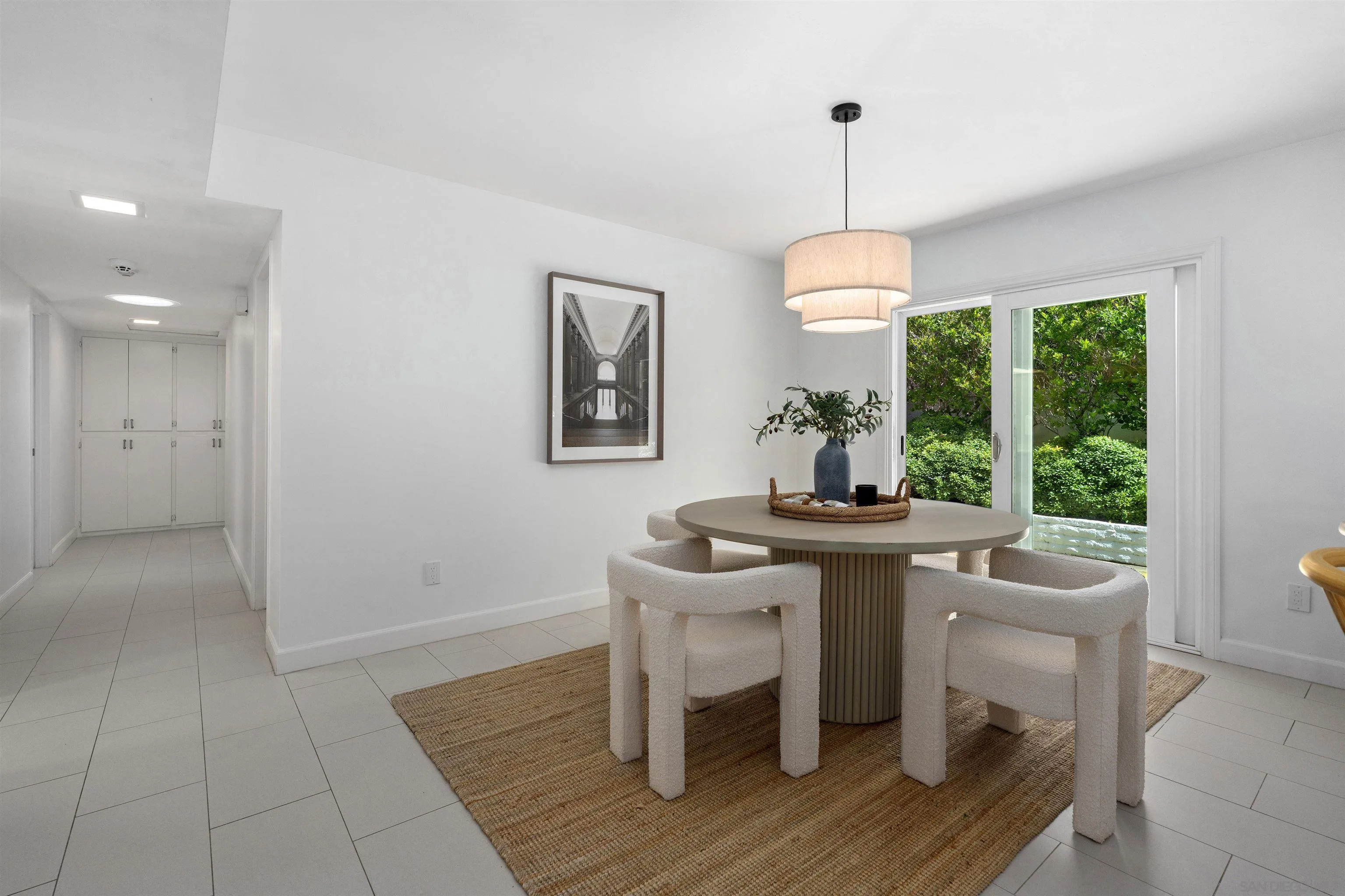 445 Avenida Primavera Del Mar, CA 92014 - Photo 23 of 44 a dining room with furniture a chandelier and wooden floor