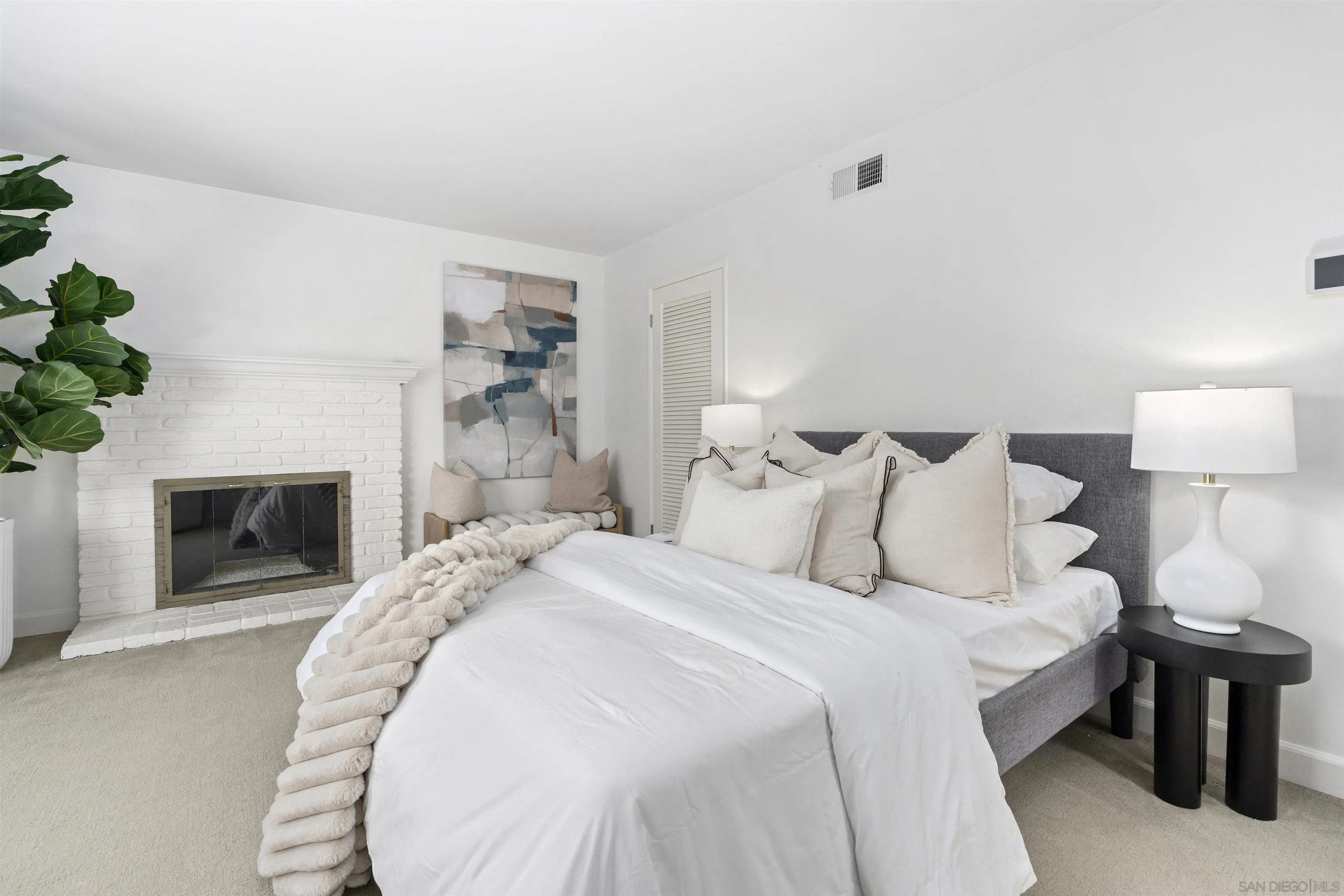 445 Avenida Primavera Del Mar, CA 92014 - Photo 30 of 44 a spacious bedroom with a bed and a fireplace