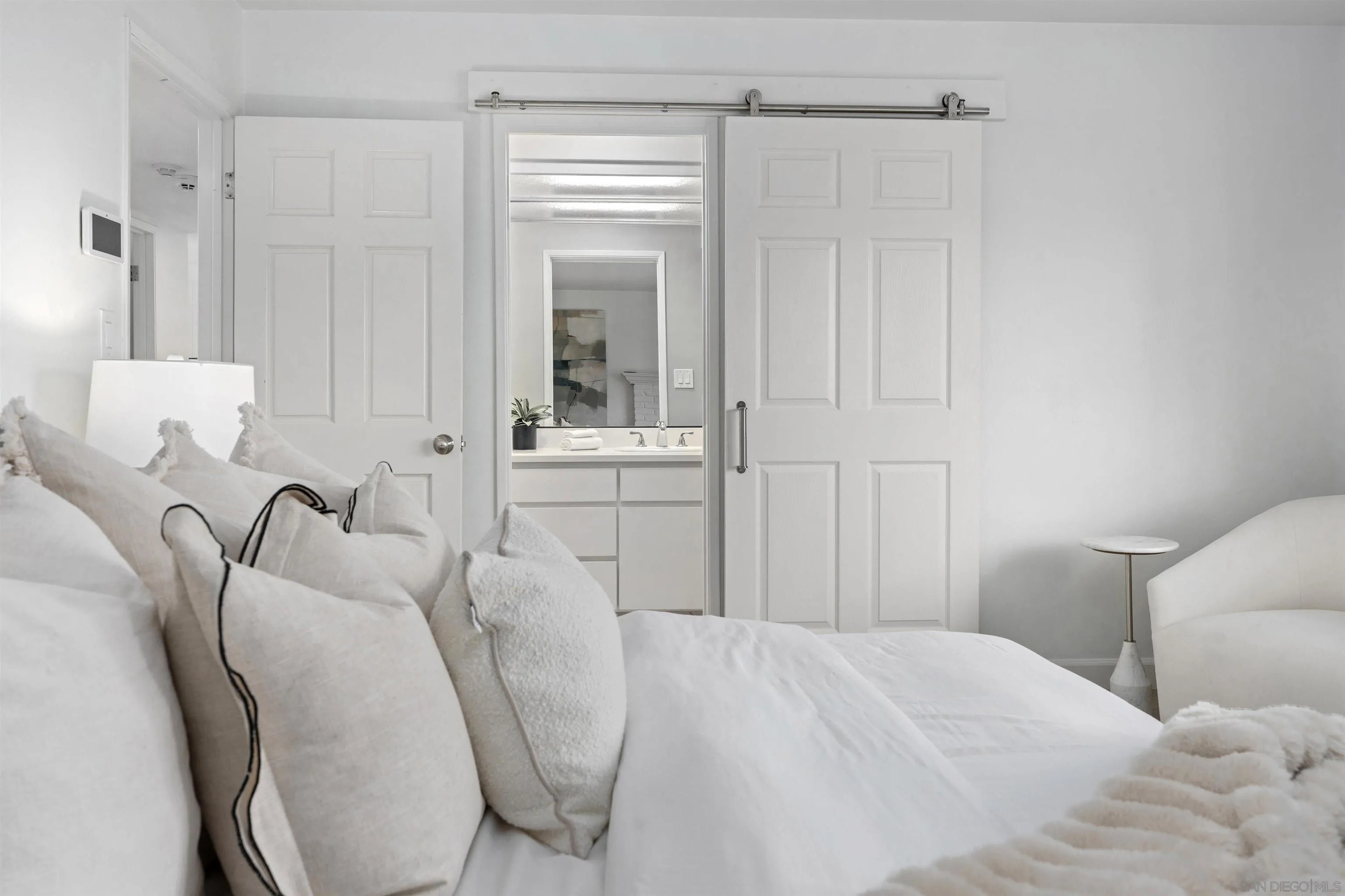 445 Avenida Primavera Del Mar, CA 92014 - Photo 31 of 44 a bedroom with a bed and a chair