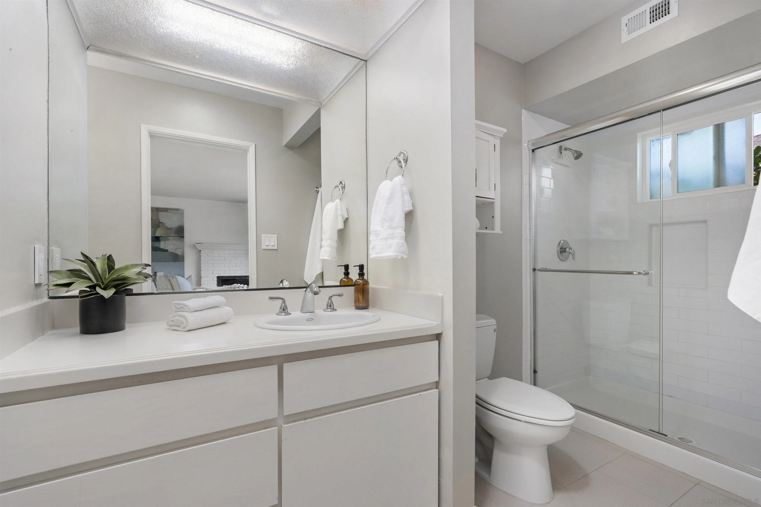 445 Avenida Primavera Del Mar, CA 92014 - Photo 33 of 44 a bathroom with a double vanity sink toilet and shower