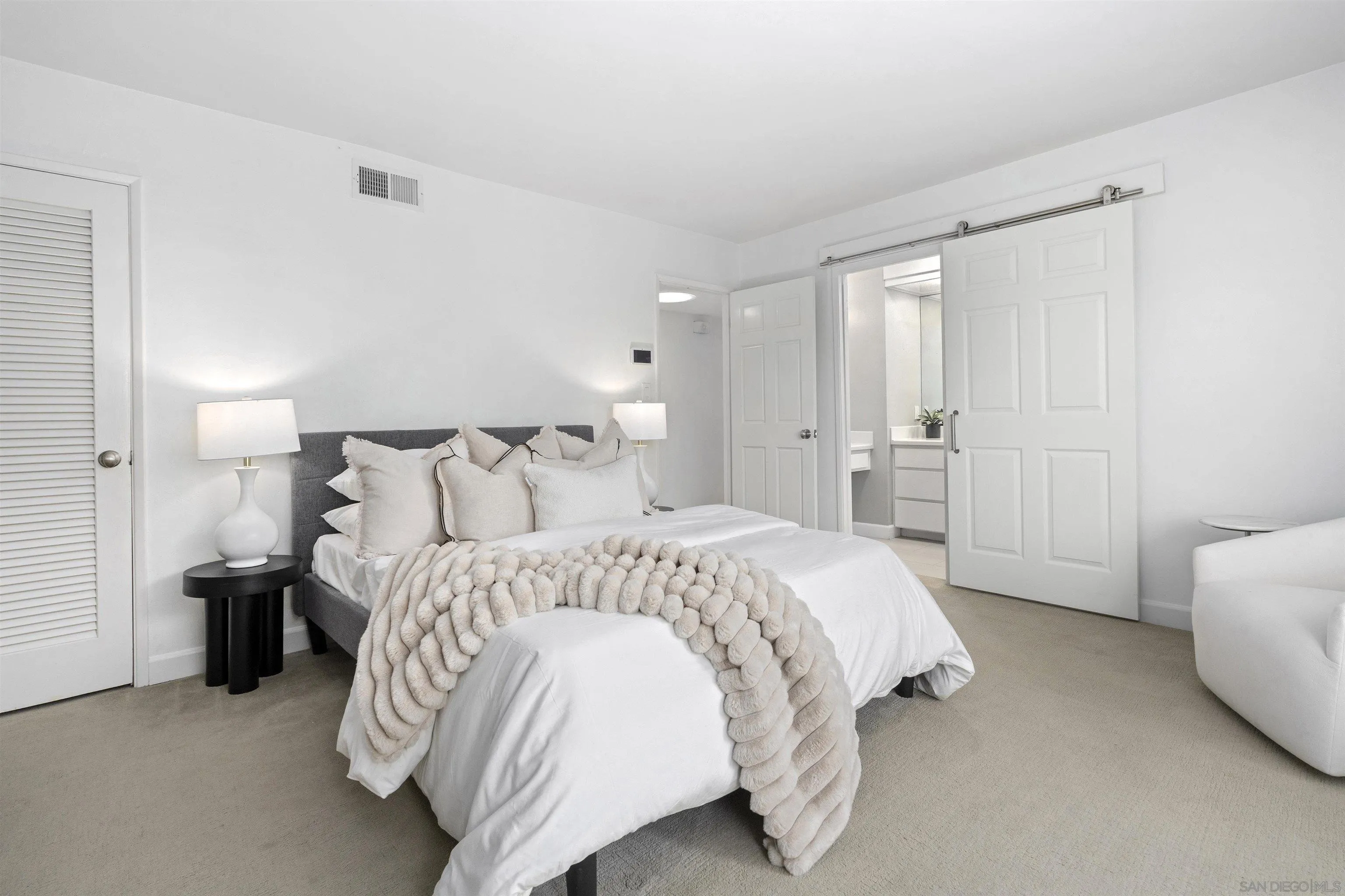 445 Avenida Primavera Del Mar, CA 92014 - Photo 37 of 44 a spacious bedroom with a bed and a couch