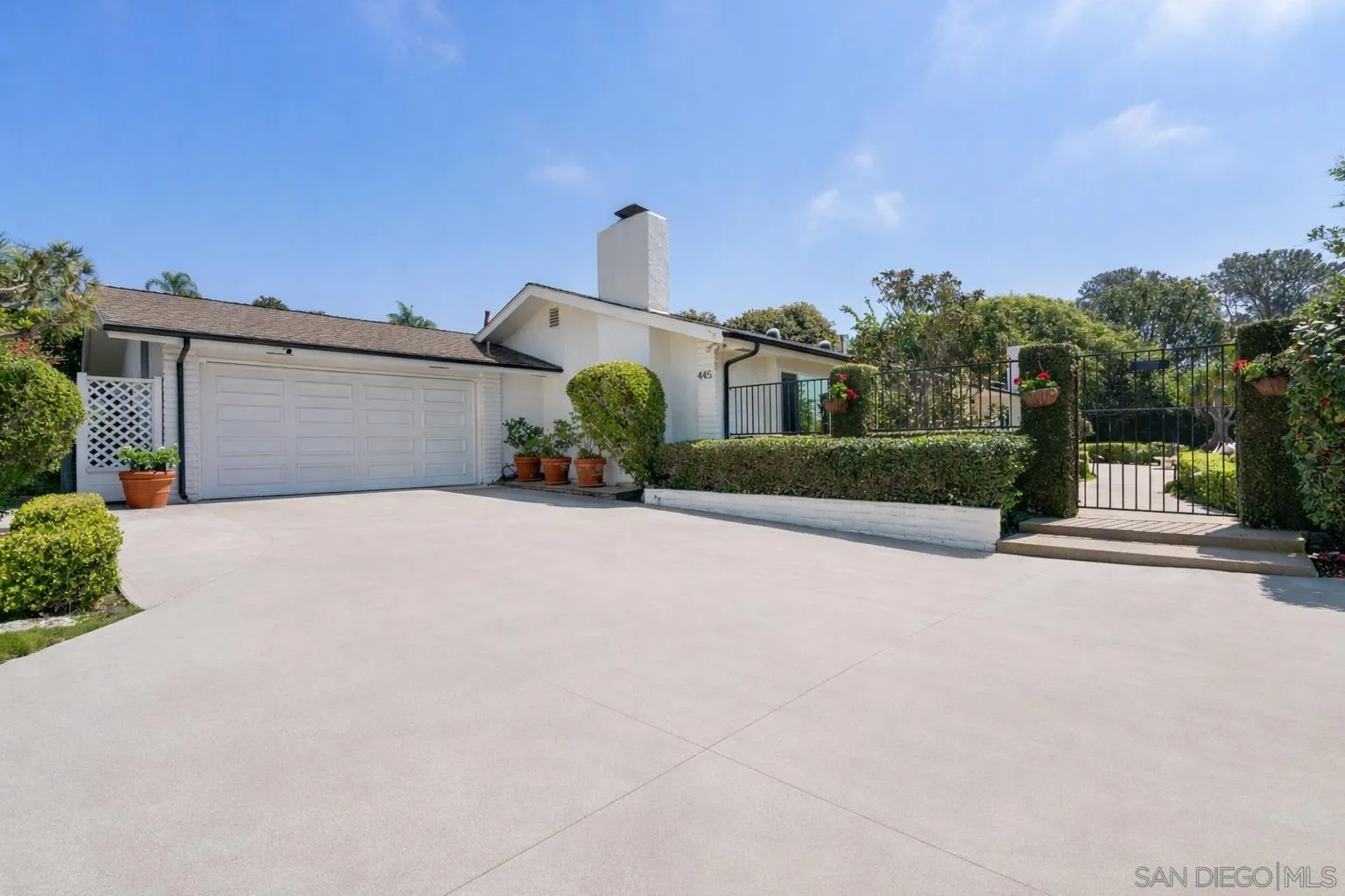 445 Avenida Primavera Del Mar, CA 92014 - Photo 4 of 44 a front view of a house with a yard and garage