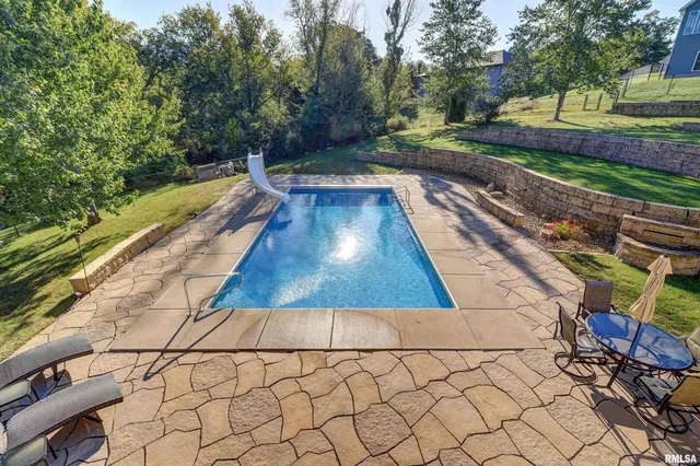 a view of a house with a yard and potted plants