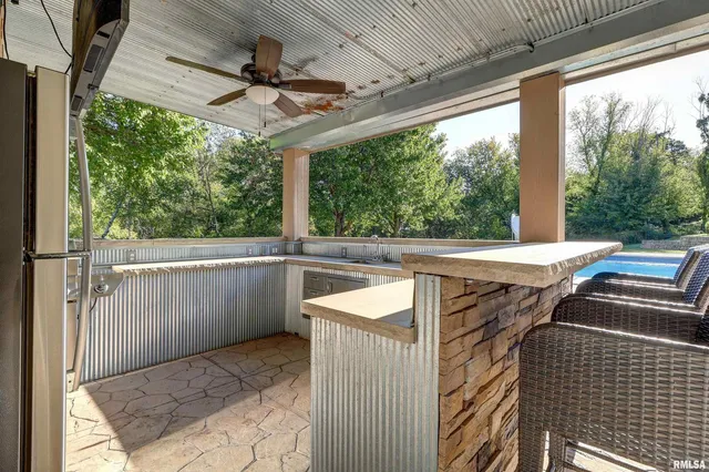 an aerial view of residential houses with outdoor space and trees