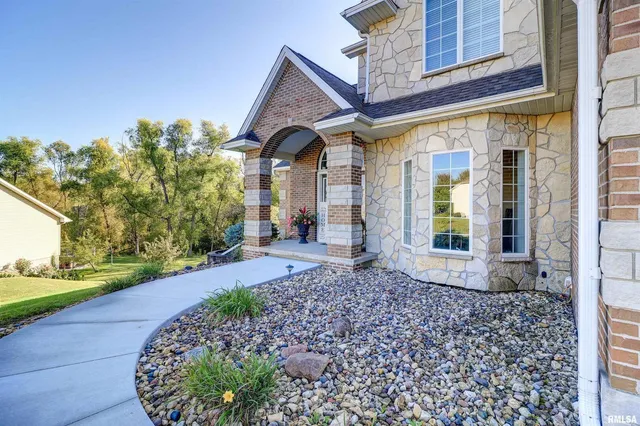 a spacious bathroom with a granite countertop sink a toilet and a mirror