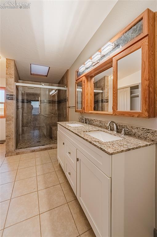 1808 County Road South Rush, CO 80833 - Photo 14 of 36 a bathroom with a granite countertop sink and a mirror