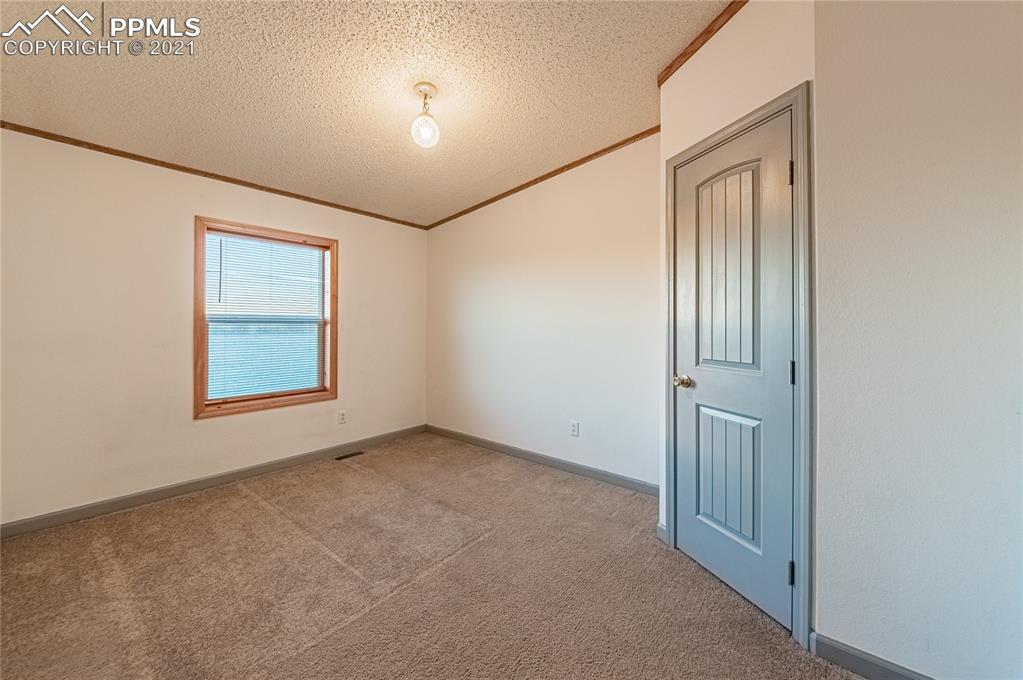 1808 County Road South Rush, CO 80833 - Photo 18 of 36 an empty room with windows and closet
