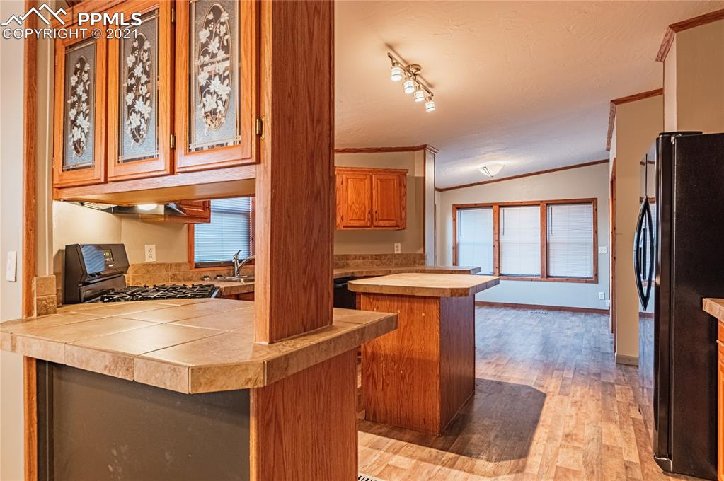1808 County Road South Rush, CO 80833 - Photo 6 of 36 a kitchen with stainless steel appliances granite countertop a sink and a refrigerator