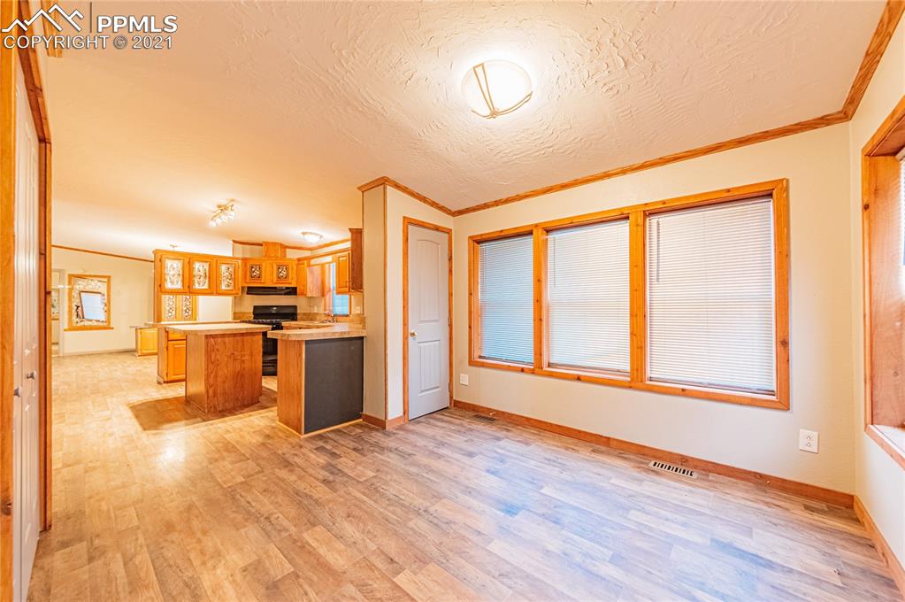 1808 County Road South Rush, CO 80833 - Photo 7 of 36 a view of a kitchen with wooden floor and a large window