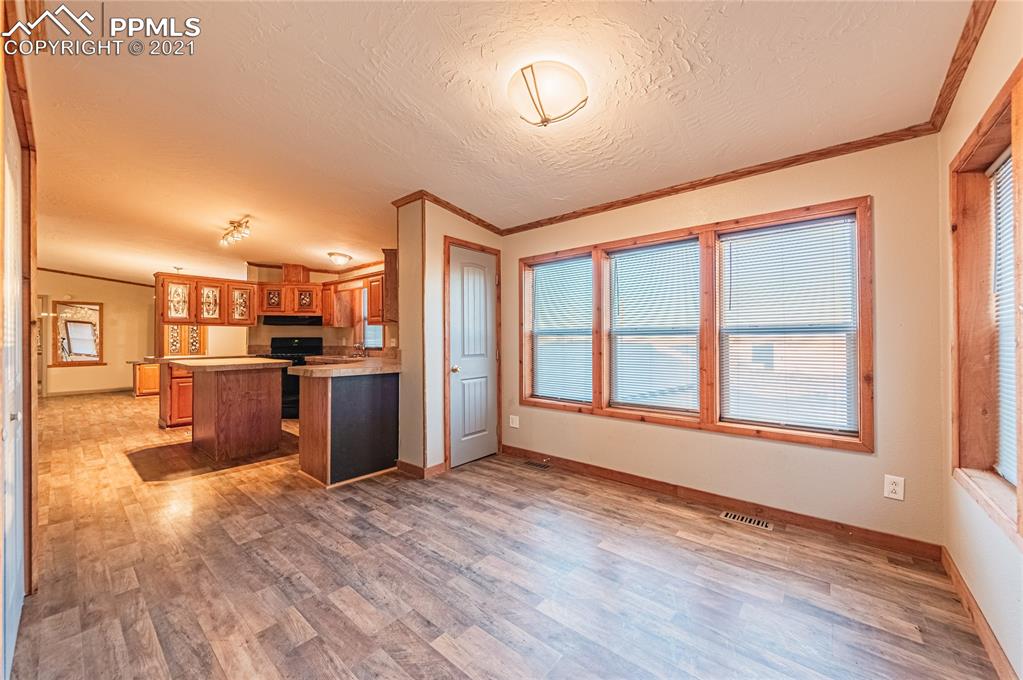 1808 County Road South Rush, CO 80833 - Photo 8 of 36 a view of a kitchen with wooden floor and a kitchen