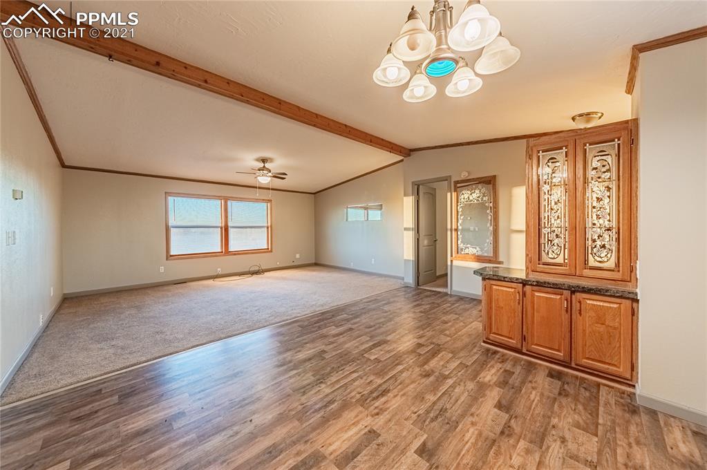 1808 County Road South Rush, CO 80833 - Photo 9 of 36 a view of an empty room with a window and wooden floor