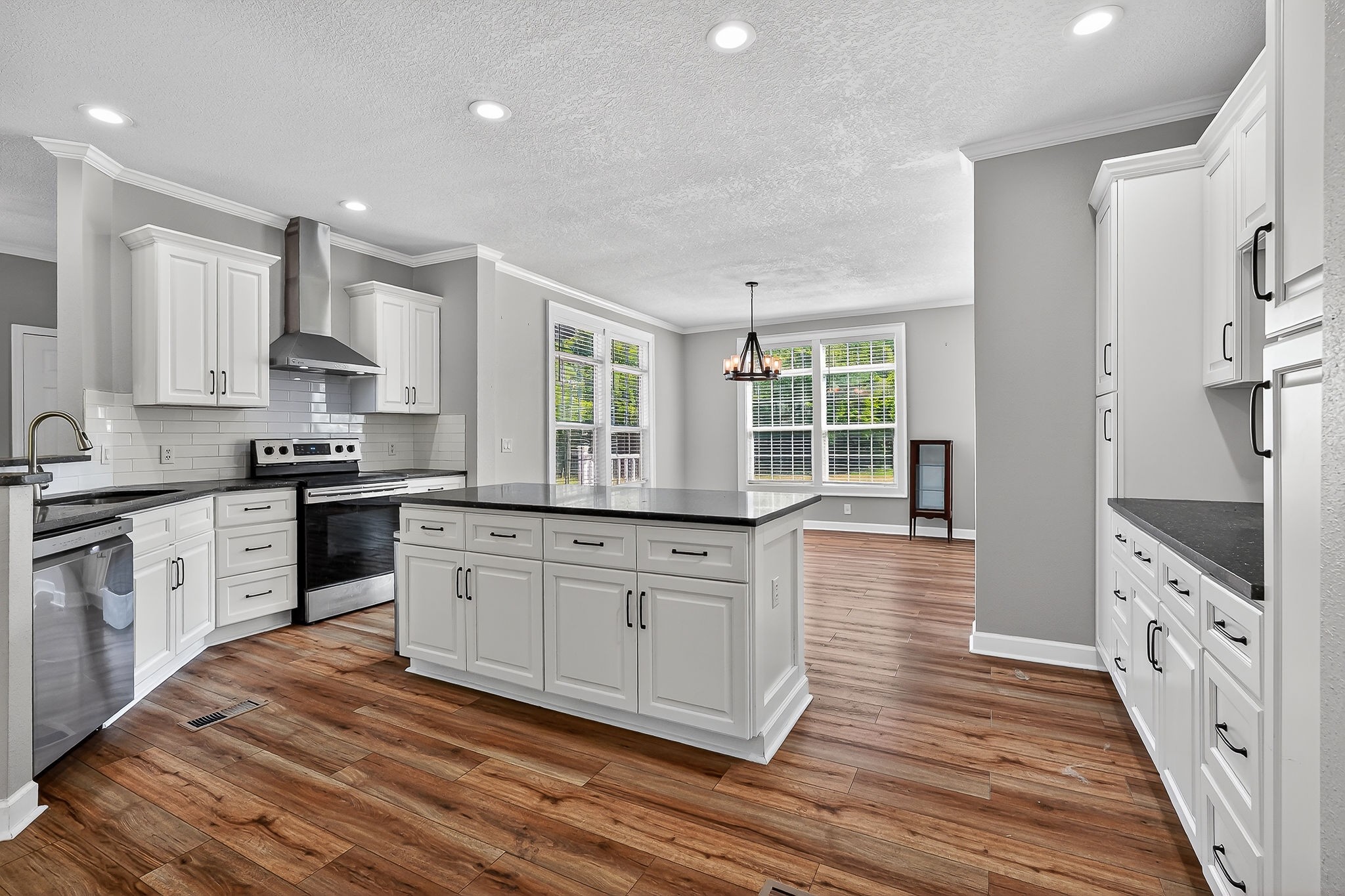 16062 Buffalo Valley Road Silver Point, TN 38582 - Photo 8 of 27 a large kitchen with stainless steel appliances granite countertop a stove a sink and white cabinets