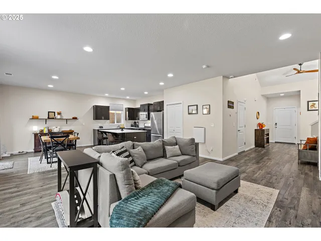 a living room with furniture and kitchen view