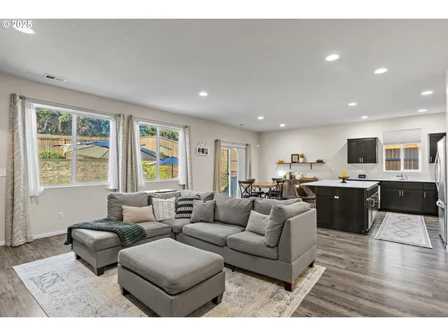 a living room with furniture and view of kitchen