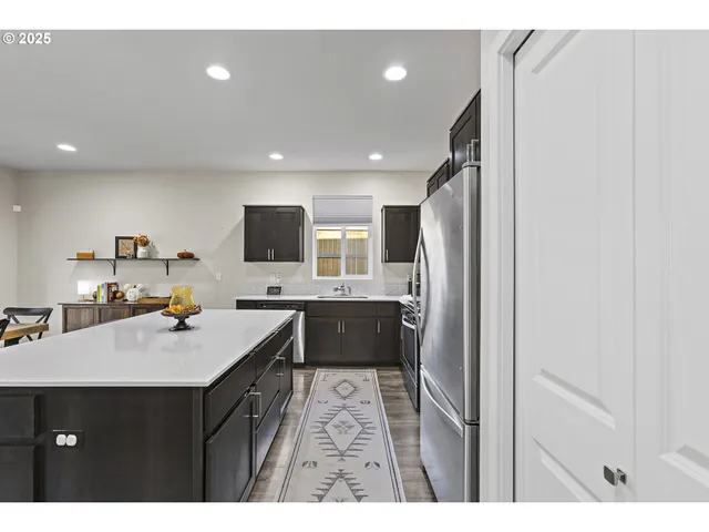 a kitchen with a sink refrigerator and microwave