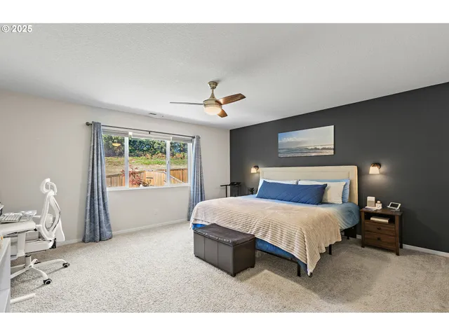 a spacious bedroom with a bed and a window