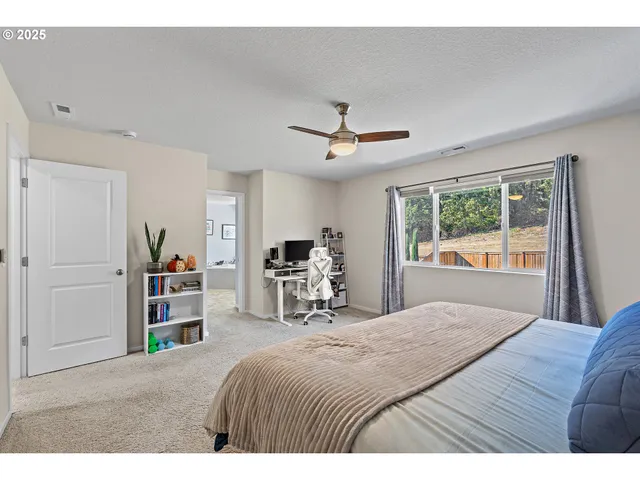 a bedroom with a bed and a book shelf