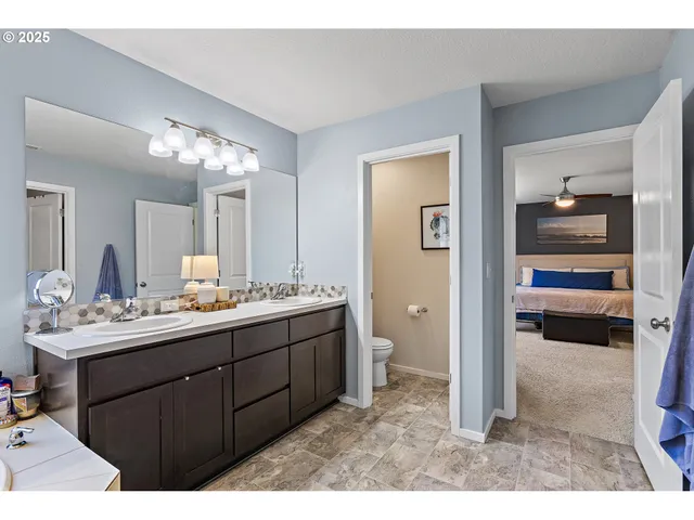 a bathroom with a sink vanity toilet and shower