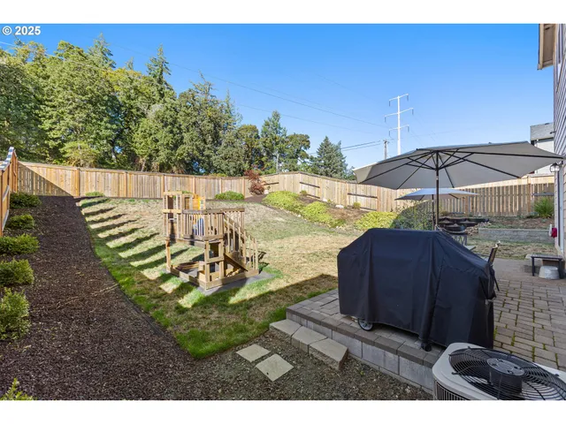a view of a house with backyard and chairs