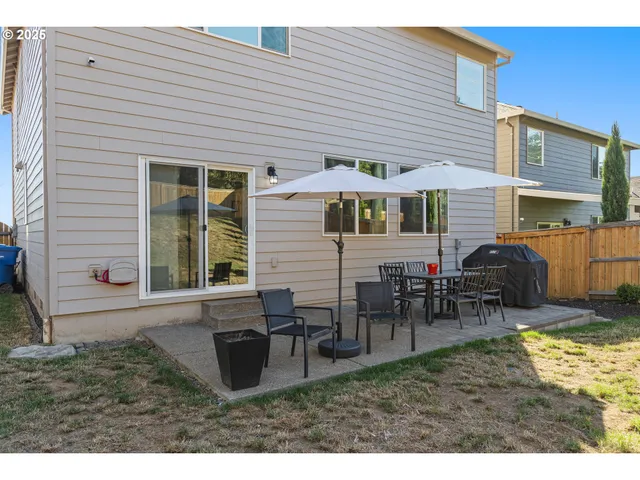 a view of a house with a yard and table