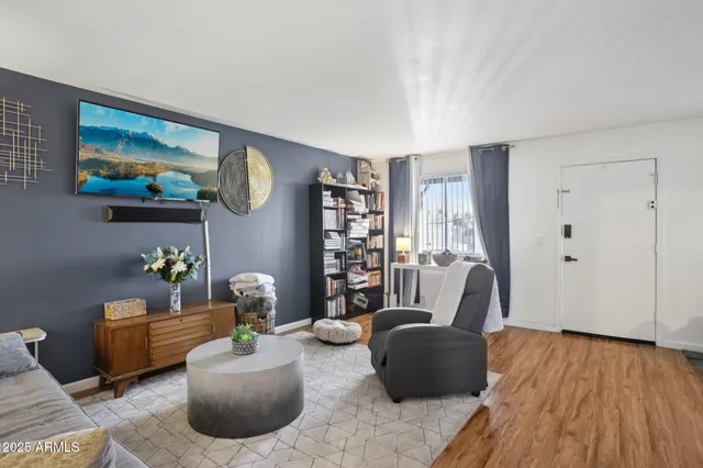 a living room with furniture and wooden floor