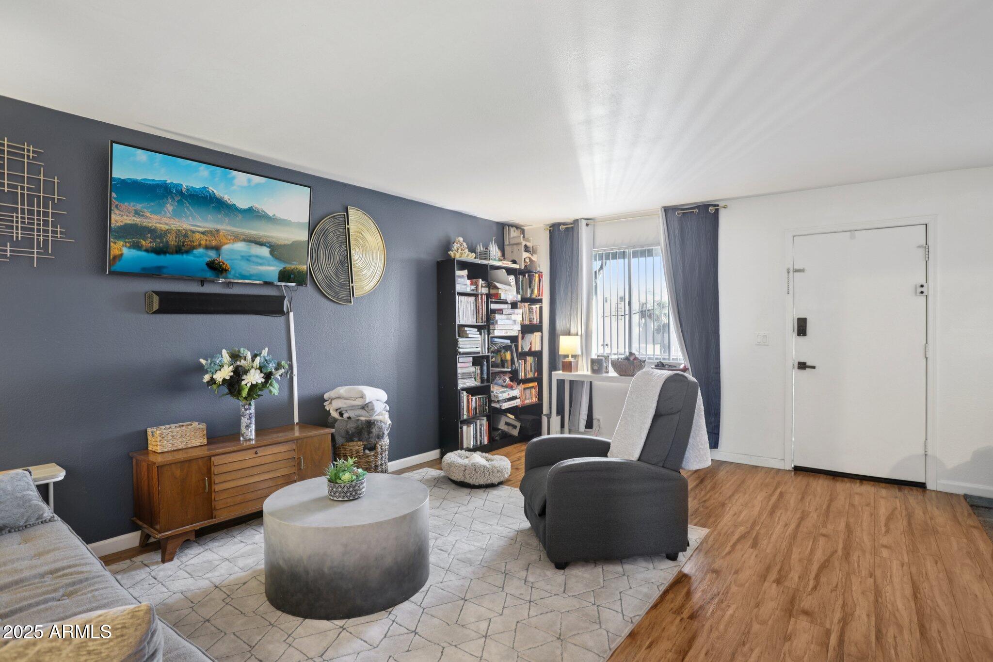 a living room with furniture and wooden floor