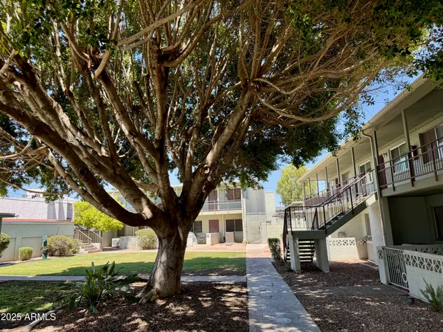a living room filled with furniture and a floor to ceiling window