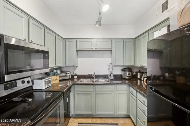 a kitchen with sink stove and cabinets