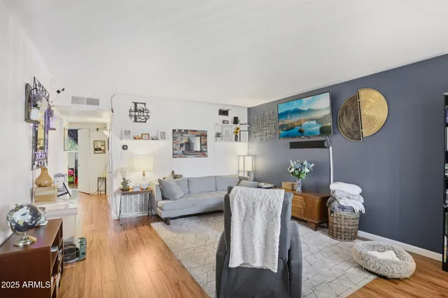a living room with furniture and a bookshelf