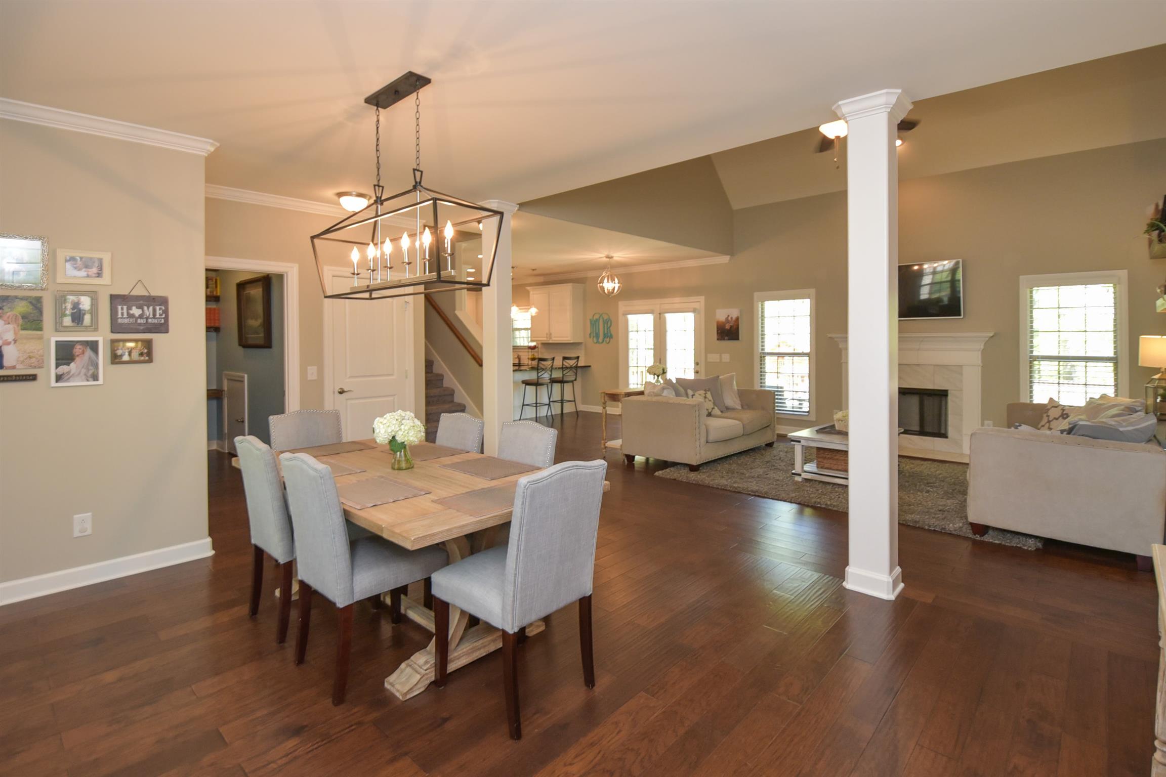 310 Independence Street Springfield, TN 37172 - Photo 13 of 29 a dining room with wooden floor a chandelier a wooden table and chairs