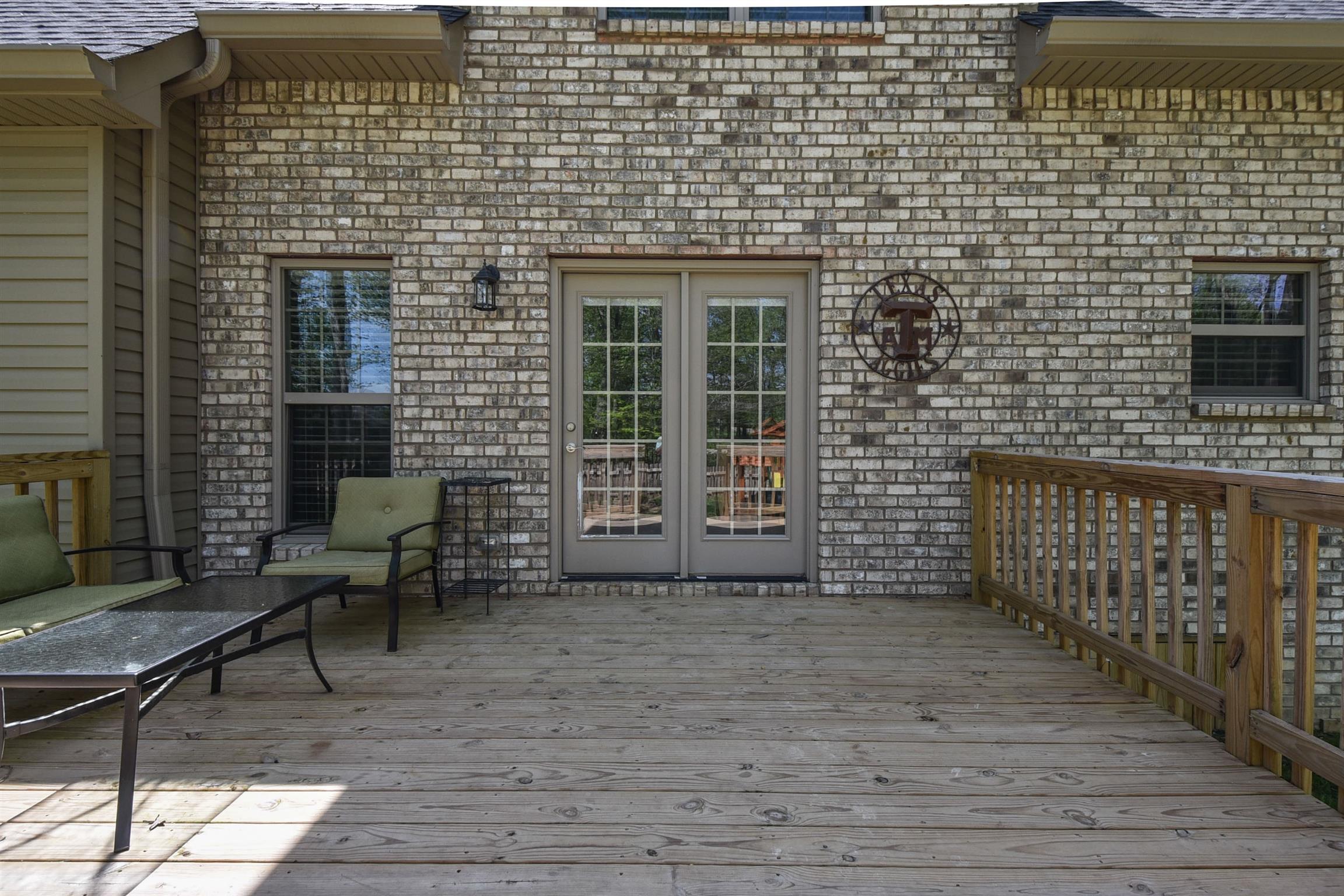 310 Independence Street Springfield, TN 37172 - Photo 5 of 29 a view of a patio with table and chairs with wooden floor and fence