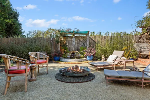 a view of a patio with couches and table and chairs and potted plants