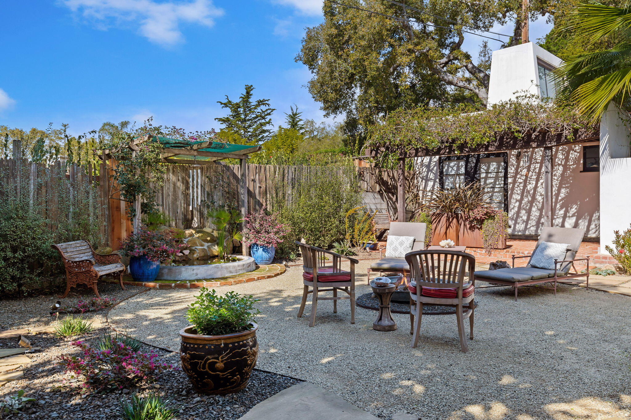 127 Hermosillo Road Montecito, CA 93108 - Photo 21 of 37 a view of a patio with couches and table and chairs and potted plants