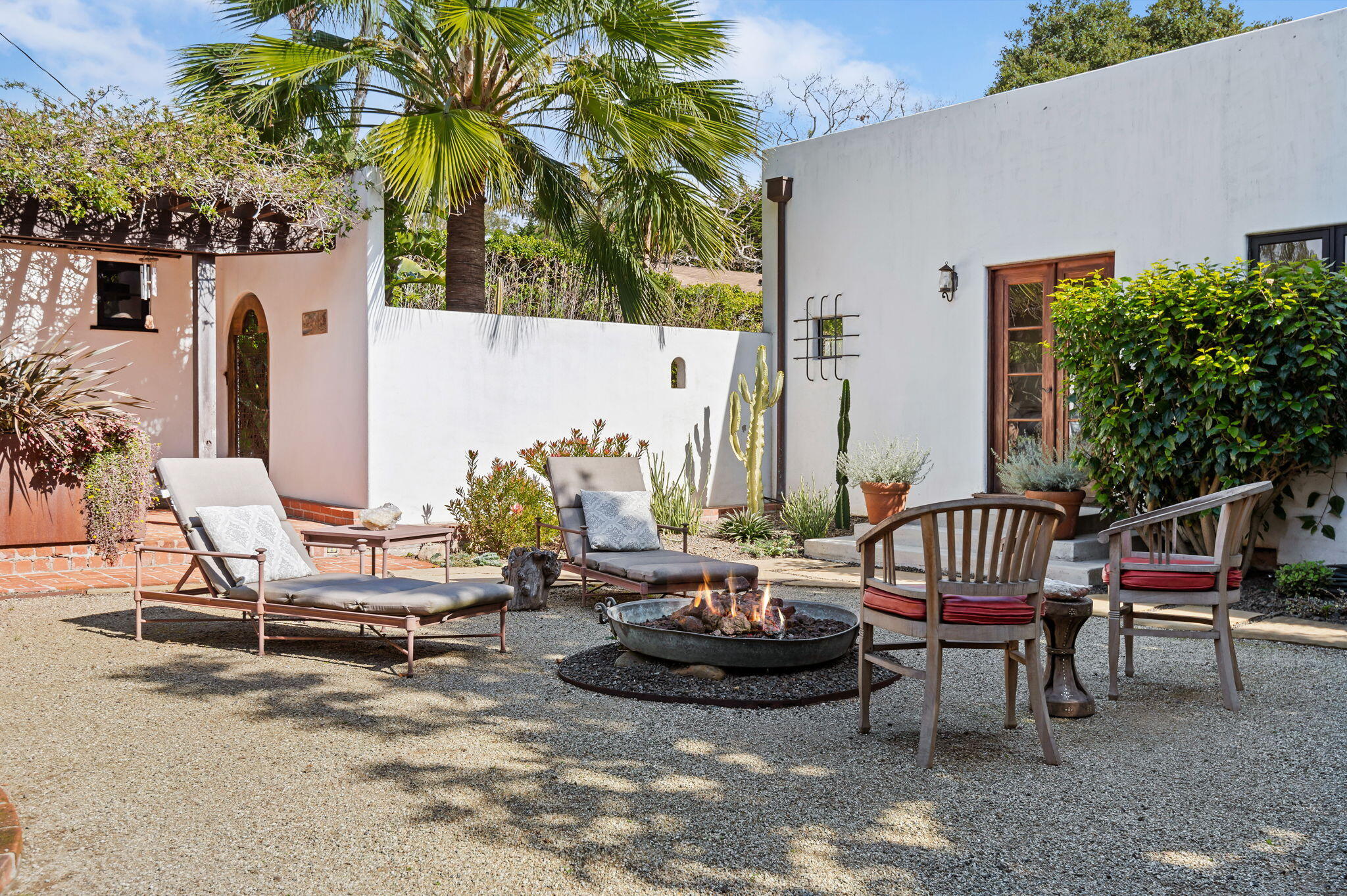 127 Hermosillo Road Montecito, CA 93108 - Photo 22 of 37 a view of a patio with couple of chairs and potted plants
