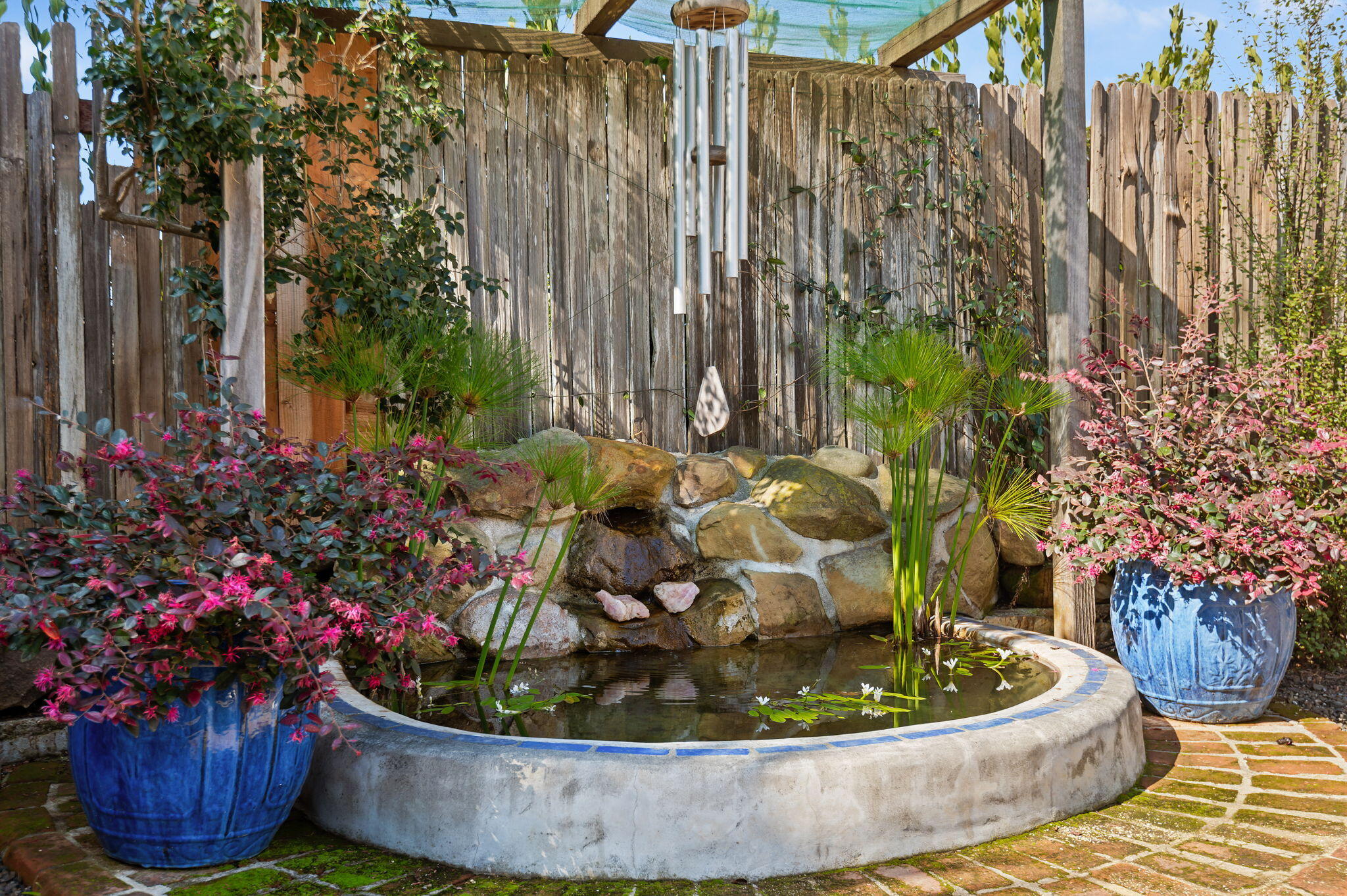 127 Hermosillo Road Montecito, CA 93108 - Photo 23 of 37 a coffee table with a potted plant and a wooden fence