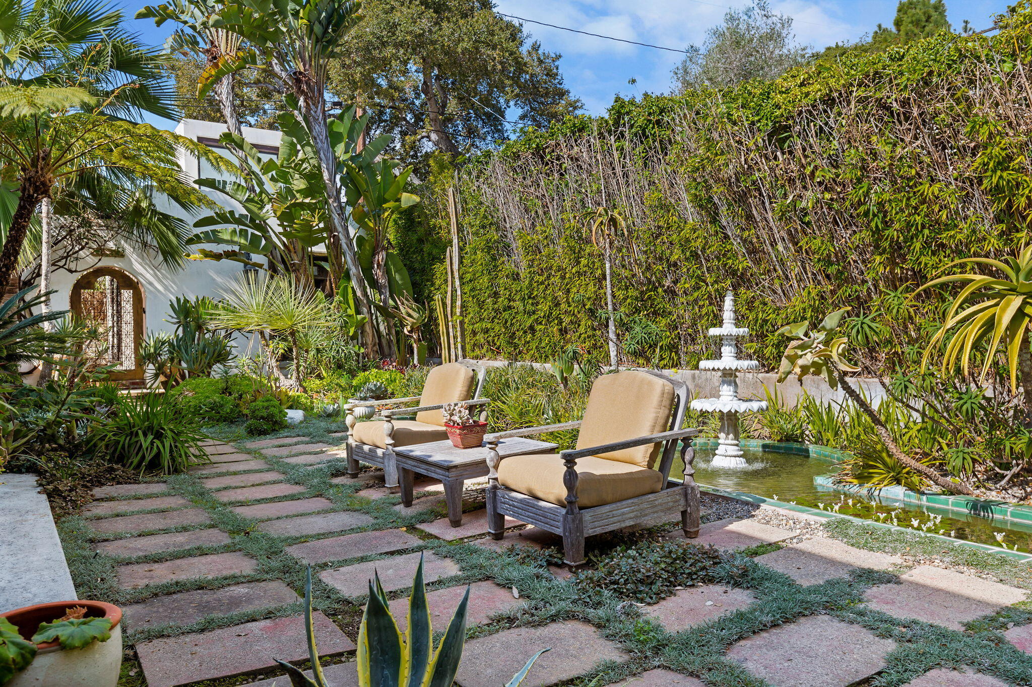 127 Hermosillo Road Montecito, CA 93108 - Photo 28 of 37 a backyard of a house with fountain table and chairs