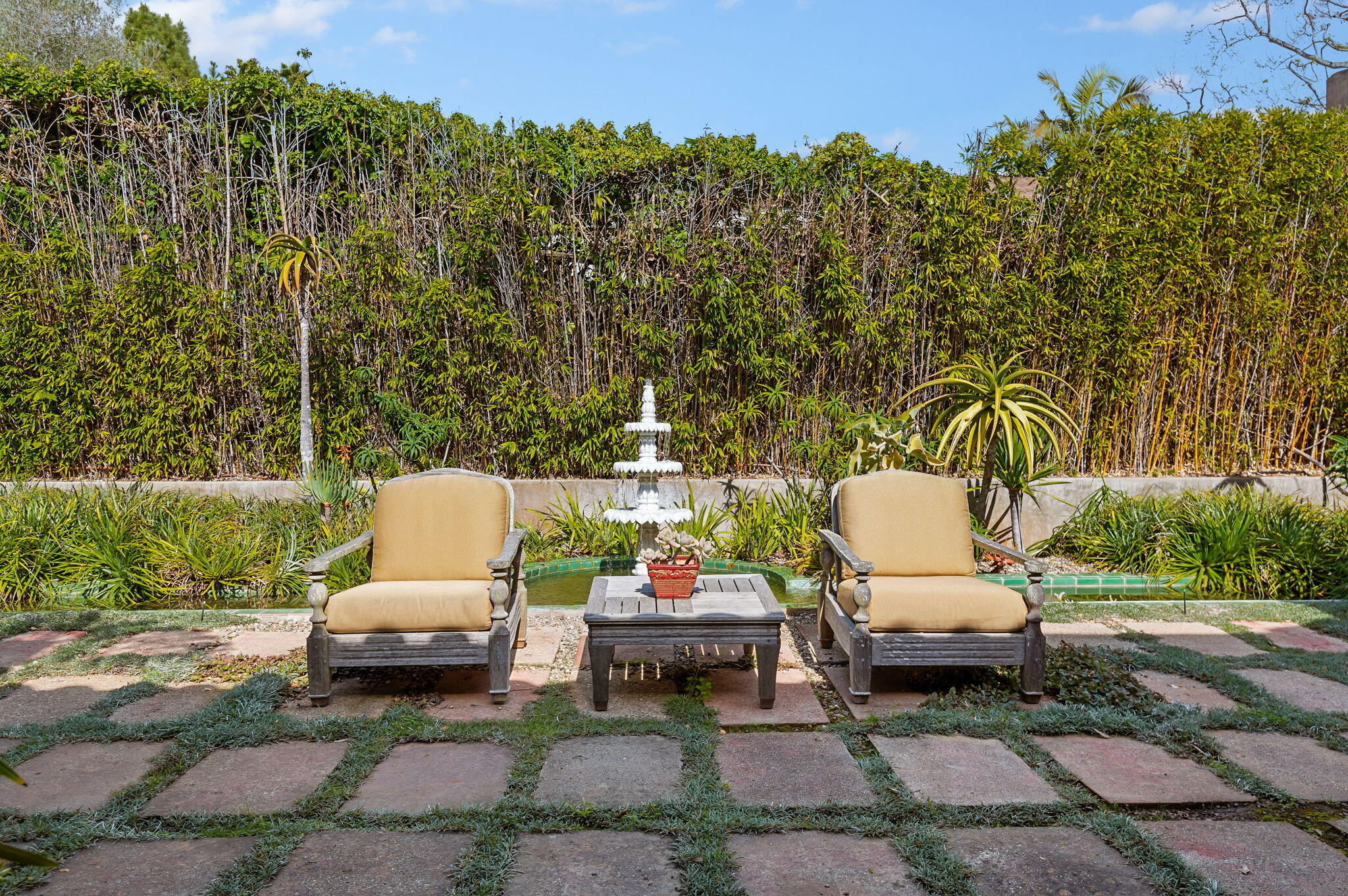 127 Hermosillo Road Montecito, CA 93108 - Photo 30 of 37 a backyard of a house with table and chairs