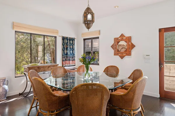 a dining room with furniture a chandelier and window