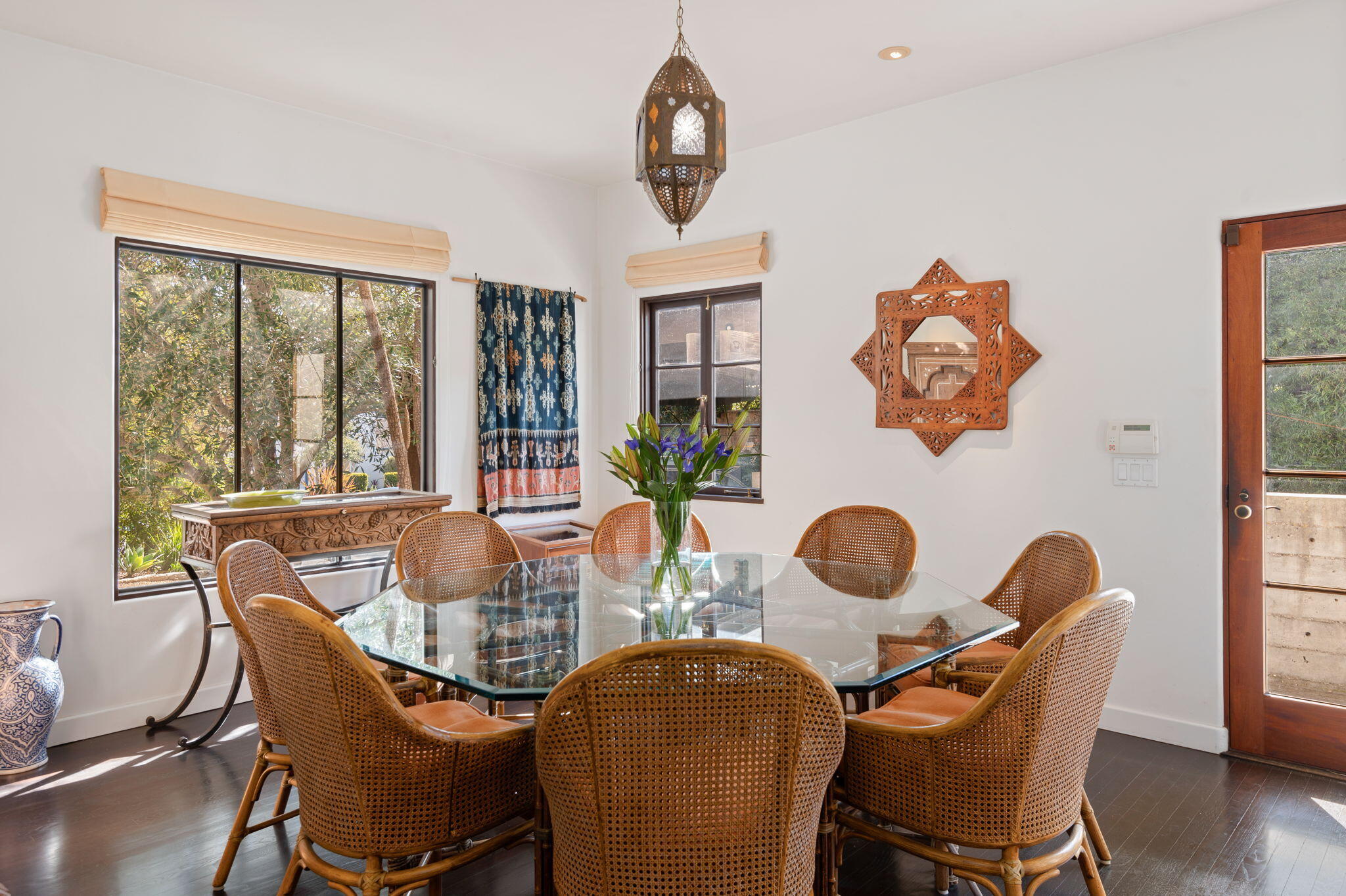 127 Hermosillo Road Montecito, CA 93108 - Photo 9 of 37 a dining room with furniture a potted plant and wooden floor