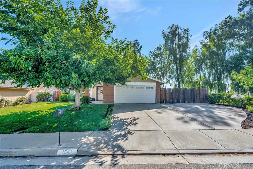a front view of a house with a yard and a garage