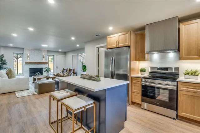 a kitchen with a stove a refrigerator and a fireplace