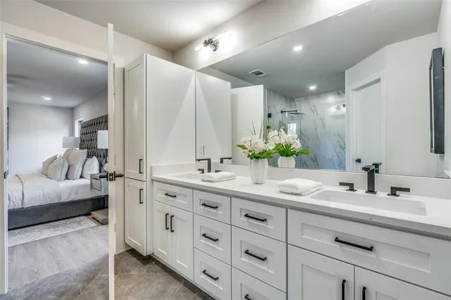 a bathroom with a double vanity sink and mirror