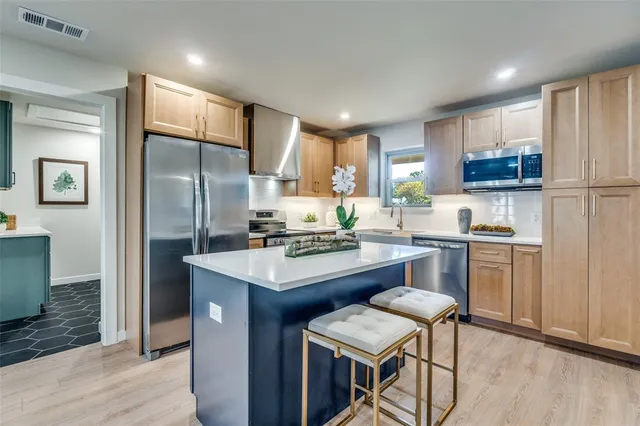 a kitchen with a refrigerator a stove a sink and a refrigerator